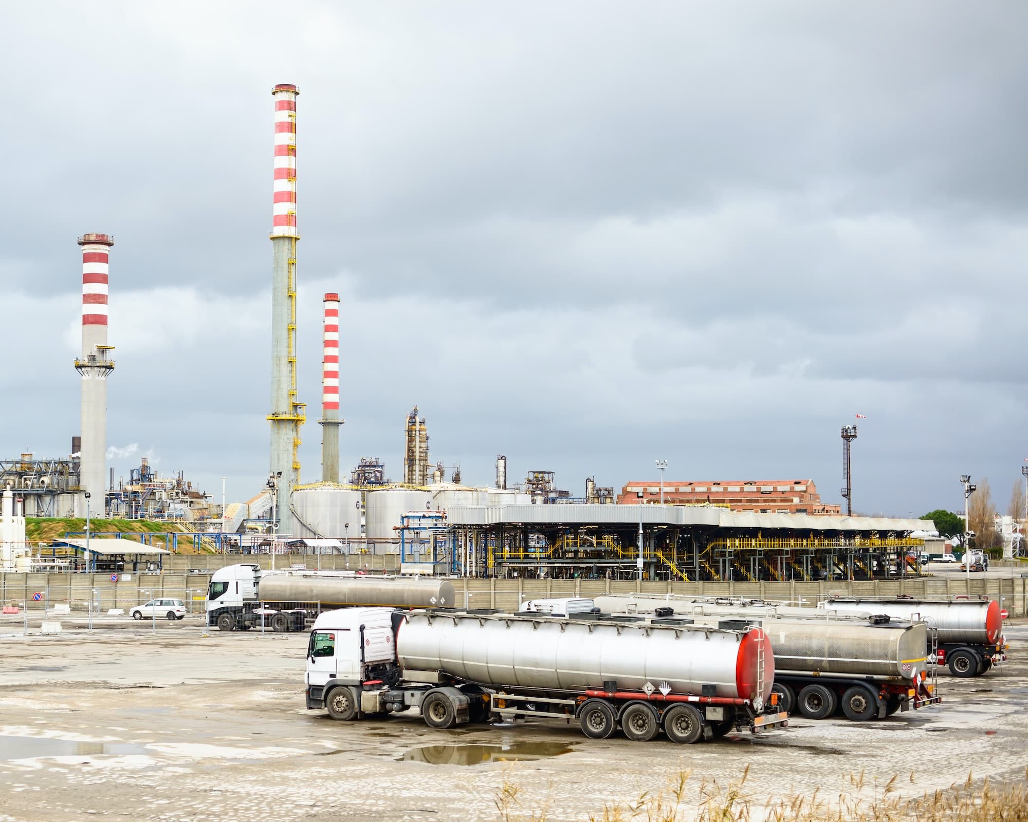 oil-refinery-industry-smoke-stacks-and-tanker-lorry-or-truck.jpg